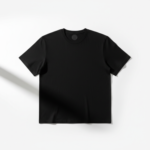 Minimal flat lay of a plain black t-shirt on a white background
